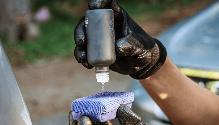 detailer applying a ceramic coat to an applicator pag