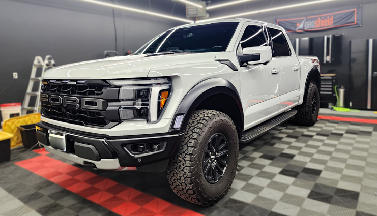 a parked detailed ford truck in a car detailing shop with patterned floor tiling